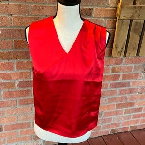 Red sleeveless top with pleats on the top left shoulder …pull over … no zipper
